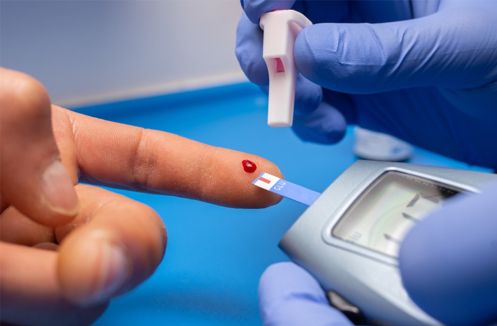 Doctor taking blood sample to check diabetes