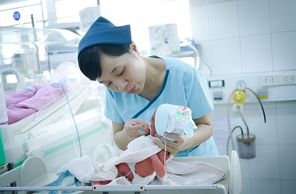 Nurse weighing a baby in the neonatal care.